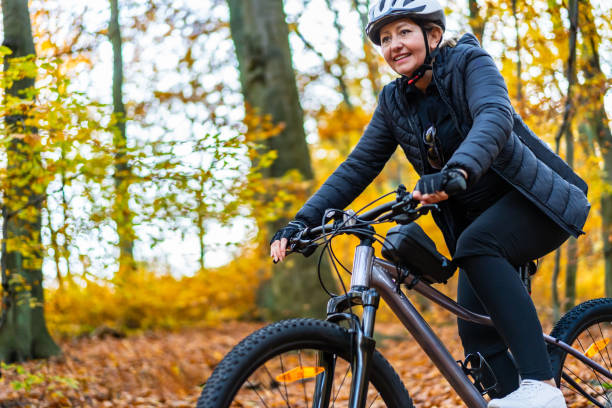 istock Woman riding bicycle in forest 2149490700