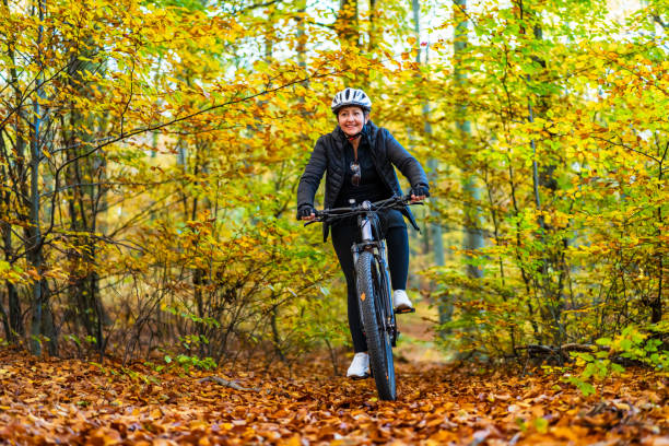 istock Woman riding bicycle in forest 2149490770