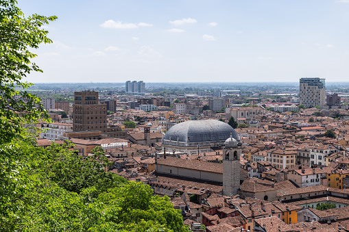 Overlooking Brescia historic center, the iconic dome of Palazzo della Loggia stands prominent among the tapestry of terracotta roofs and modern skyscrapers