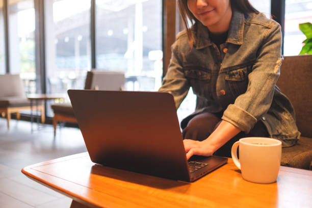 istock Closeup image of a woman working and touching on laptop computer touchpad in cafe 2149491677