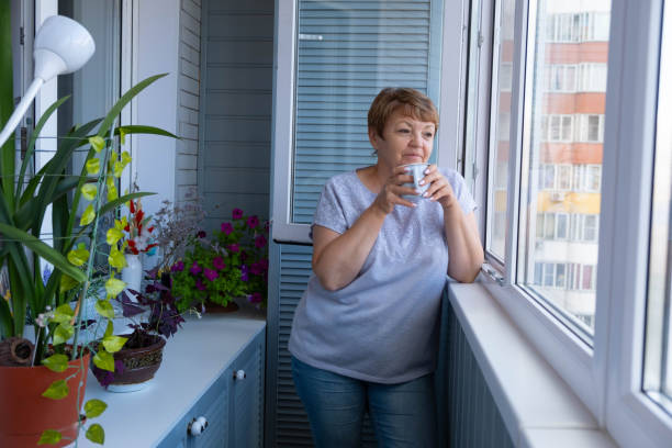 istock An attractive elderly woman drinks coffee on the balcony. Enjoying life 2149492006