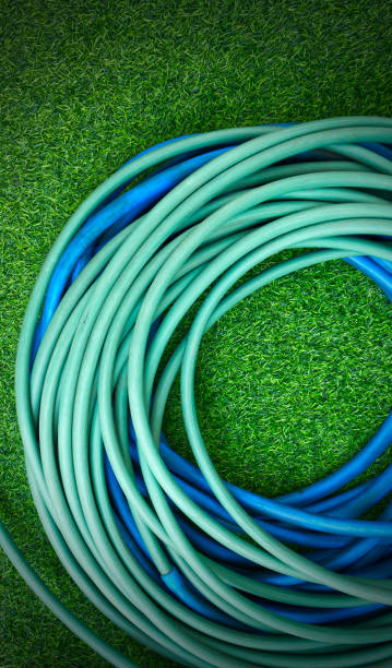 istock The hose watering plants on green artificial grass 2149493541