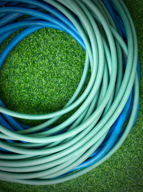 istock The hose watering plants on green artificial grass 2149493543