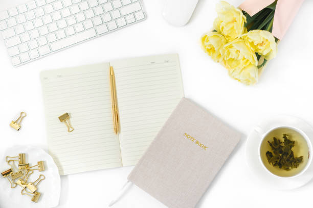 istock Office Desk table. Flat lay, top view. Home office workspace of a freelancer or blogger. A keyboard, a mouse, a bunch of tulips, a Cup of green tea, and a Notepad with a pen. 2149495193