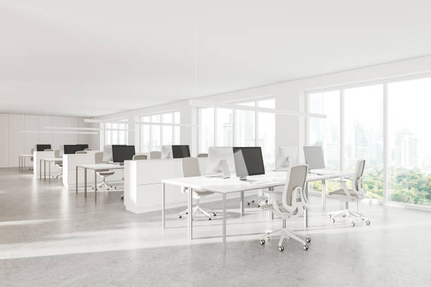 istock White office coworking interior with desk and pc monitors, panoramic window 2149496163