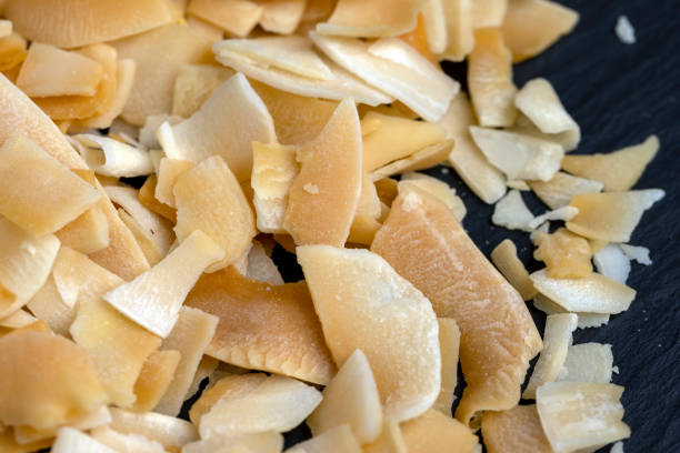 istock sweet orange and yellow coconut flakes fried in sugar 2149496804