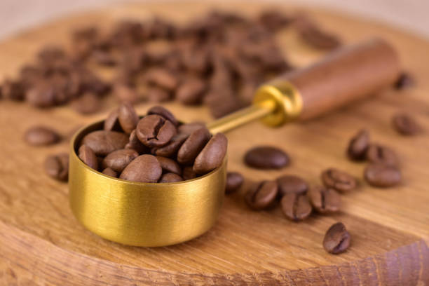 istock Ground coffee in a spoon on a background of coffee beans. Close-up. Selective focus. 2149497122