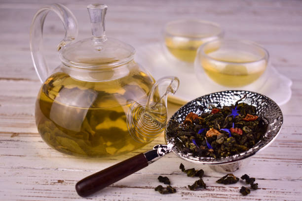 istock Green tea in a glass teapot. Warm drinks concept. 2149497139