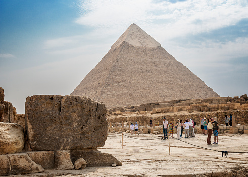 Pyramid of Khafre, Giza - October 8, 2023:  Tourists and the pyramid of Khafre (or the pyramid of Chephren) in Giza. Egypt, north Africa.