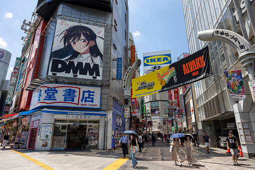 Tokyo, Japan - June 29, 2023 : People at Shibuya District, Tokyo, Japan. It is a famous shopping district in Tokyo. Many department stores, boutiques, restaurants, and game centers are located in this district.