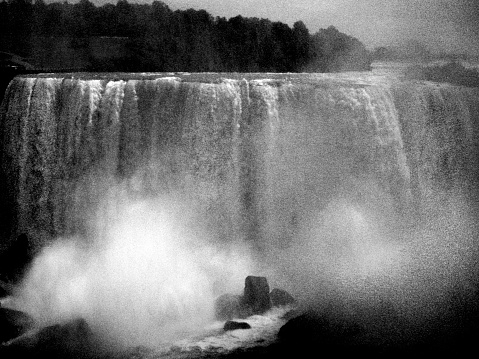 Niagara Falls, black and white front view Horseshoe Falls close-up, water spraying. Ontario, Canada.