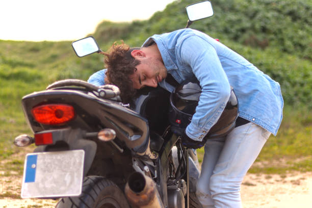 istock Curly haired Caucasian young man affectionately hugging his motorcycle 2149501014