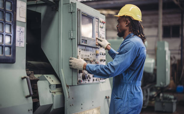 istock Technician adjusts and troubleshoots factory machinery for optimal performance and safety standard 2149501477