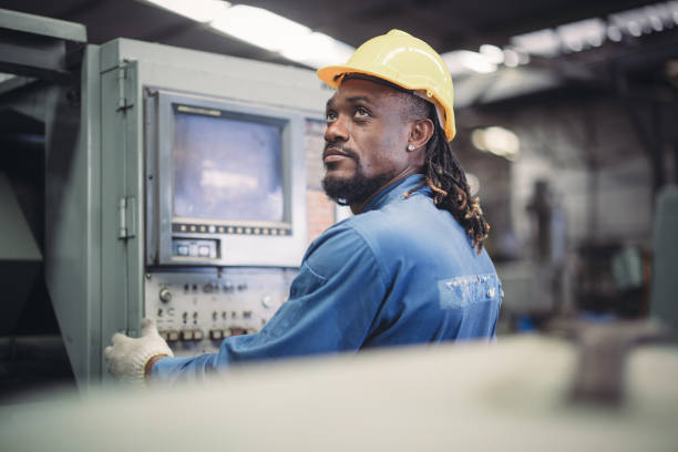 istock Technician adjusts and troubleshoots factory machinery for optimal performance and safety standard 2149501478