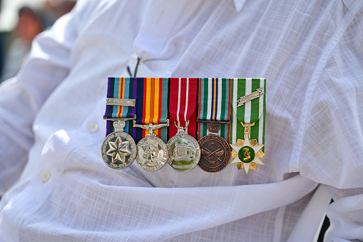A man wears medals on his chest for ANZAC Day.