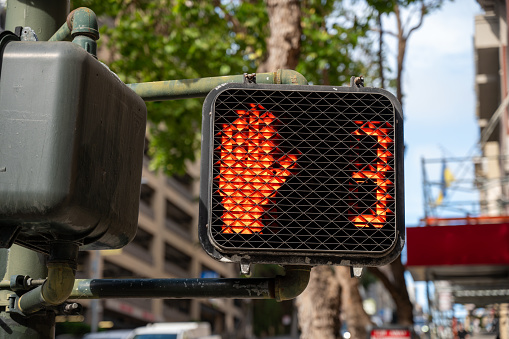 Pedestrian crossing light signal showing the red hand to say do not walk, in San Francisco during springtime day