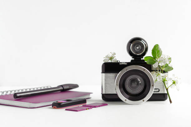 istock isolated on white background camera, notebook with pen, memory cards, spring tree twig, place for text, learning concept 1 2149501709