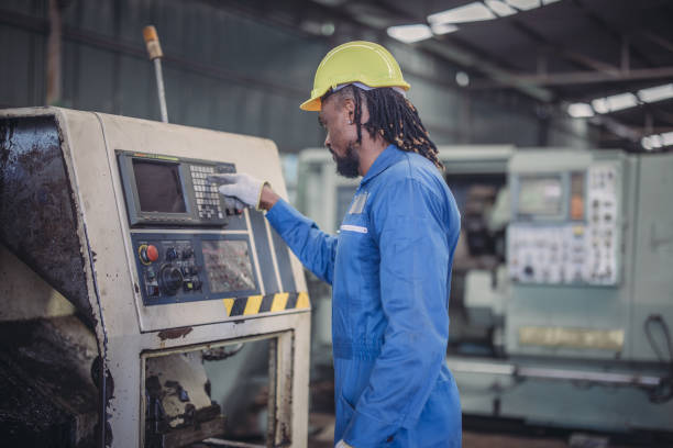 istock Technician adjusts and troubleshoots factory machinery for optimal performance and safety standard 2149501834