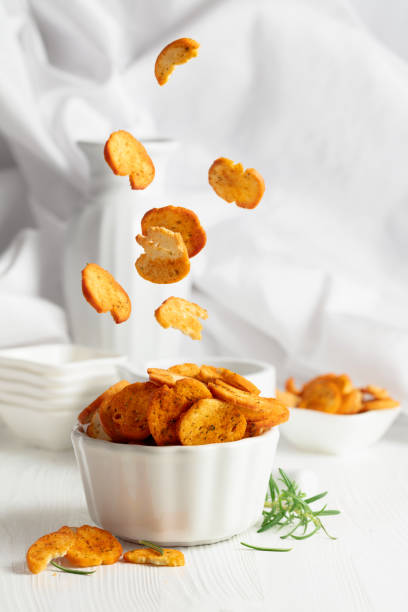 istock Spicy bruschetta crackers with rosemary on a white kitchen table. 2149502531