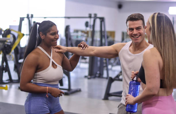 istock Group of multiracial smiling people talking to each other inside a gym 2149502877