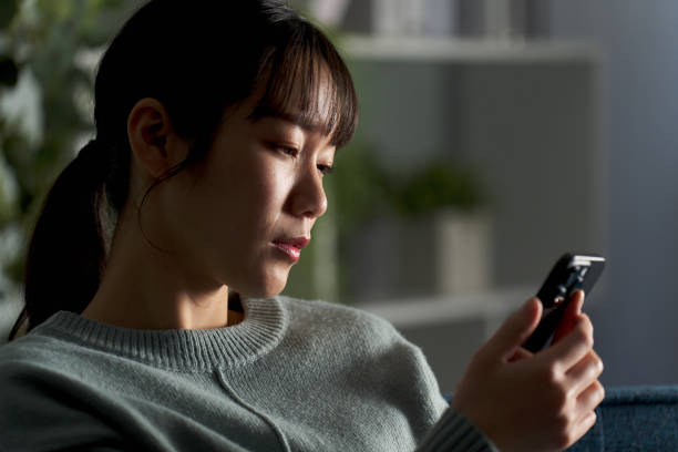 istock A depressed woman looking at her smartphone 2149502911