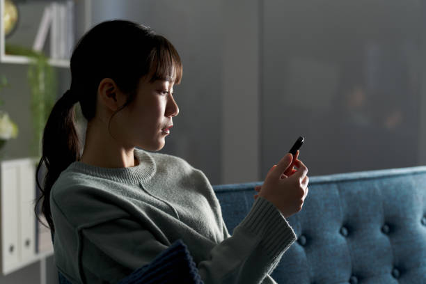 istock A depressed woman looking at her smartphone 2149502914