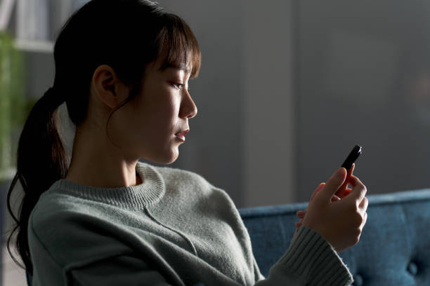 istock A depressed woman looking at her smartphone 2149502918