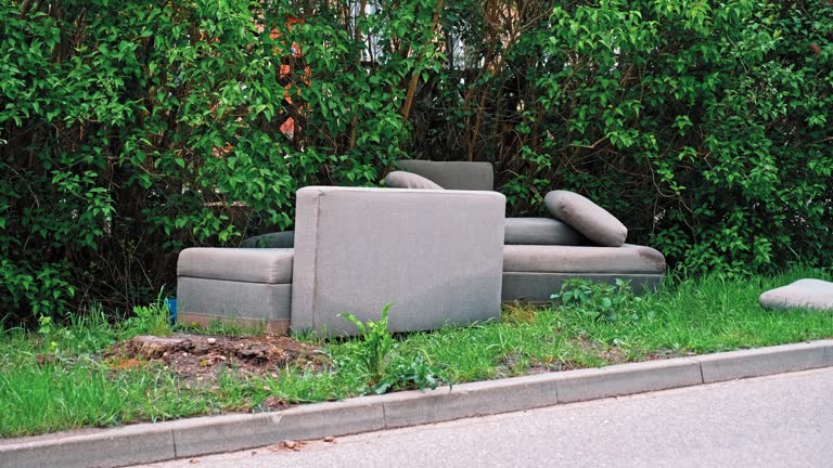 Old Dirty Couch Household Furniture Dumped Outdoor for Scheduled Curbside Bulk Garbage Pickup by City Cleaning Services