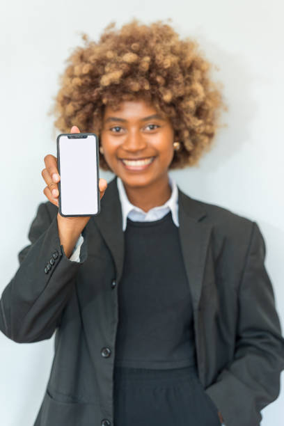 istock Smiling woman showing a mobile phone with blank white screen 2149503321