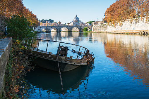 A boat wreck in the Tiber River. In the background St. Angelo Bridge.