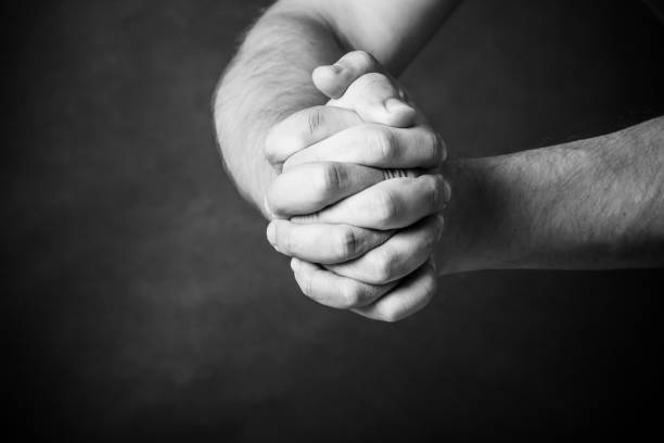 istock Man`s hands on black background. Stay strong. Stick together. 2149505295