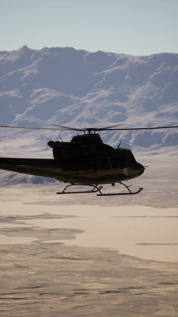 Helicopter Flying Over Mountain Range
