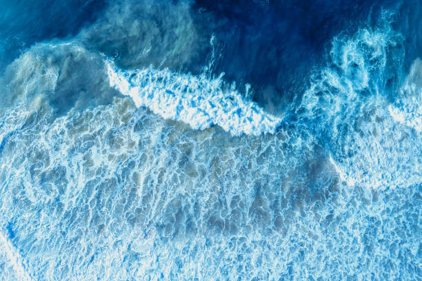 istock Ocean surf. Waves roll onto the shore. View from above. Natural abstract background 2149508213