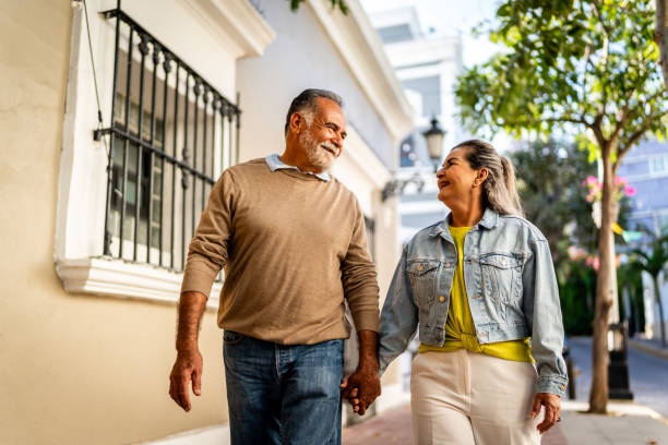 istock Senior couple talking and walking through the city 2149509633