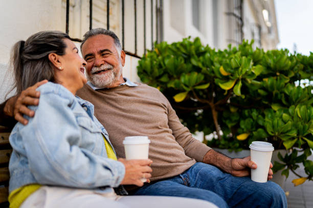 istock Senior couple talking sitting on bench outdoors 2149509668