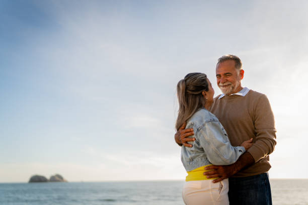 istock Senior couple embracing and dancing on coastline beach 2149509758