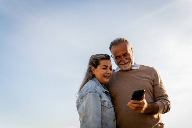 istock Senior couple using mobile phone outdoors 2149509767