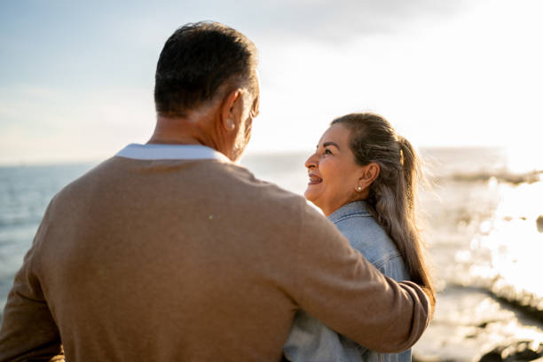 istock Senior couple talking on coastline pier 2149509893