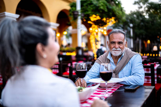 istock Senior man and wife talking on dinner at outdoors restaurant 2149509917