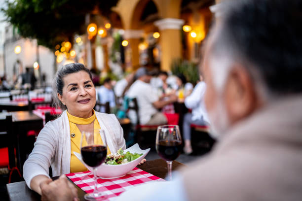 istock Senior woman and husband talking on dinner at outdoors restaurant 2149509919
