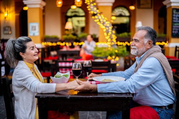 istock Senior couple talking and having dinner at outdoors restaurant 2149509938