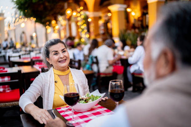 istock Senior woman and husband talking on dinner at outdoors restaurant 2149509939