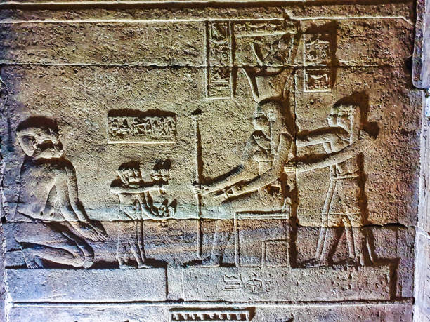 The goddess Menhit with a Uraeus (cobra) body on basket hieroglyphics at the Temple of Edfu in Edfu, Egypt.