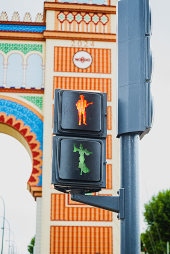 sevilla, spain april 20, 2024: detail of traffic lights in seville, decorated with colorful flamingos to indicate when to cross the street.