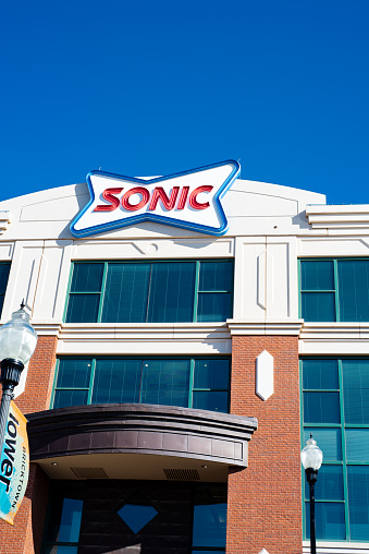 Oklahoma City, USA-MAR 10, 2024: Looking up exterior headquarters corporate office with Sonic logo trademark in Bricktown, founded in 1953, American drive-in fast-food chain owned by Inspire Brands
