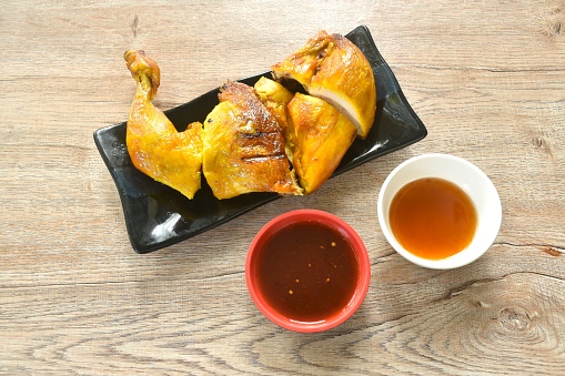 roasted chop chicken meat wing and leg on plate dipping with sweet and spicy sauce