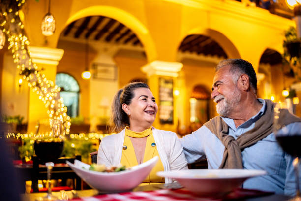istock Senior couple talking and having dinner at outdoors restaurant 2149515377