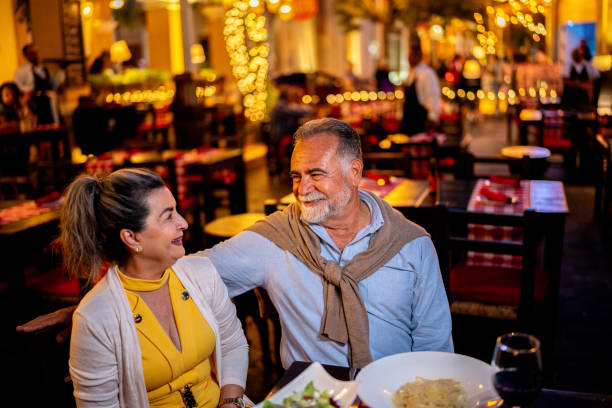 istock Senior couple talking and having dinner at outdoors restaurant 2149515427
