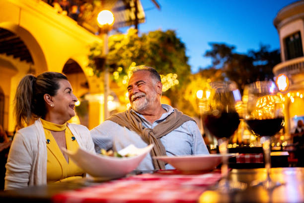 Senior couple talking and having dinner at outdoors restaurant