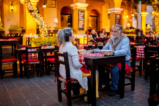 istock Senior couple talking and having dinner at outdoors restaurant 2149515985